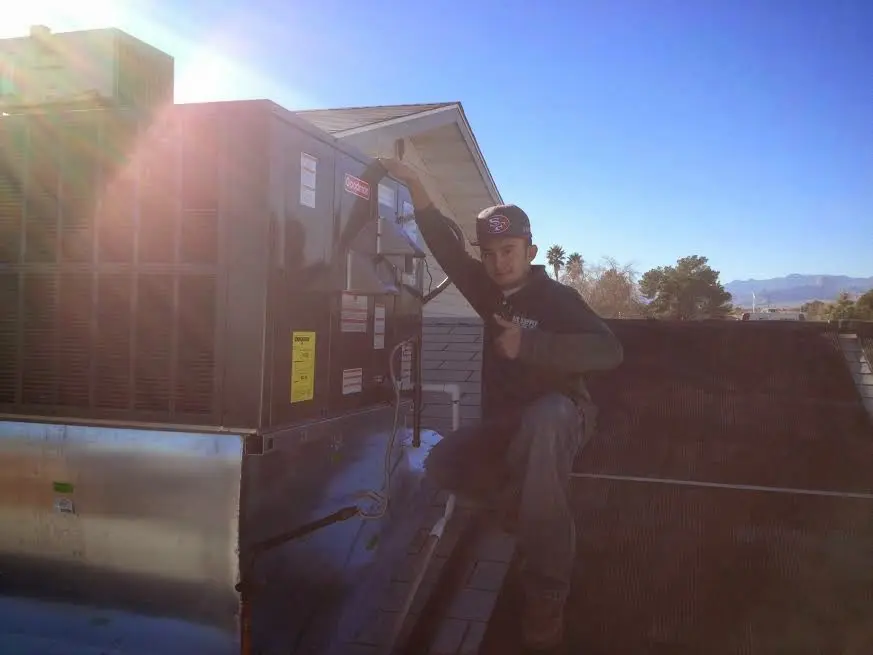 HVAC technician performing HVAC Inspection on a rooftop unit in Westborough